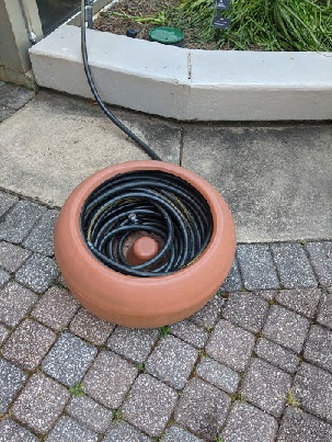 hose reel disguised as a flower pot