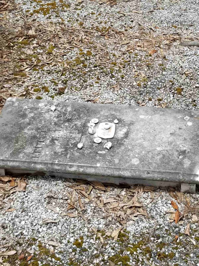 Little girl's tea set, on an old grave